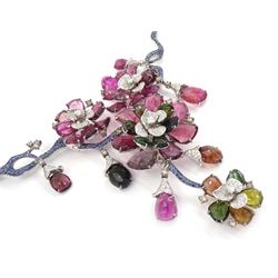 18ct white gold gemstone set floral jewellery suite, comprising necklace, pair of earrings and bracelet, each with tourmaline flower petals, round brilliant cut diamond centres and sapphire stems, stamped