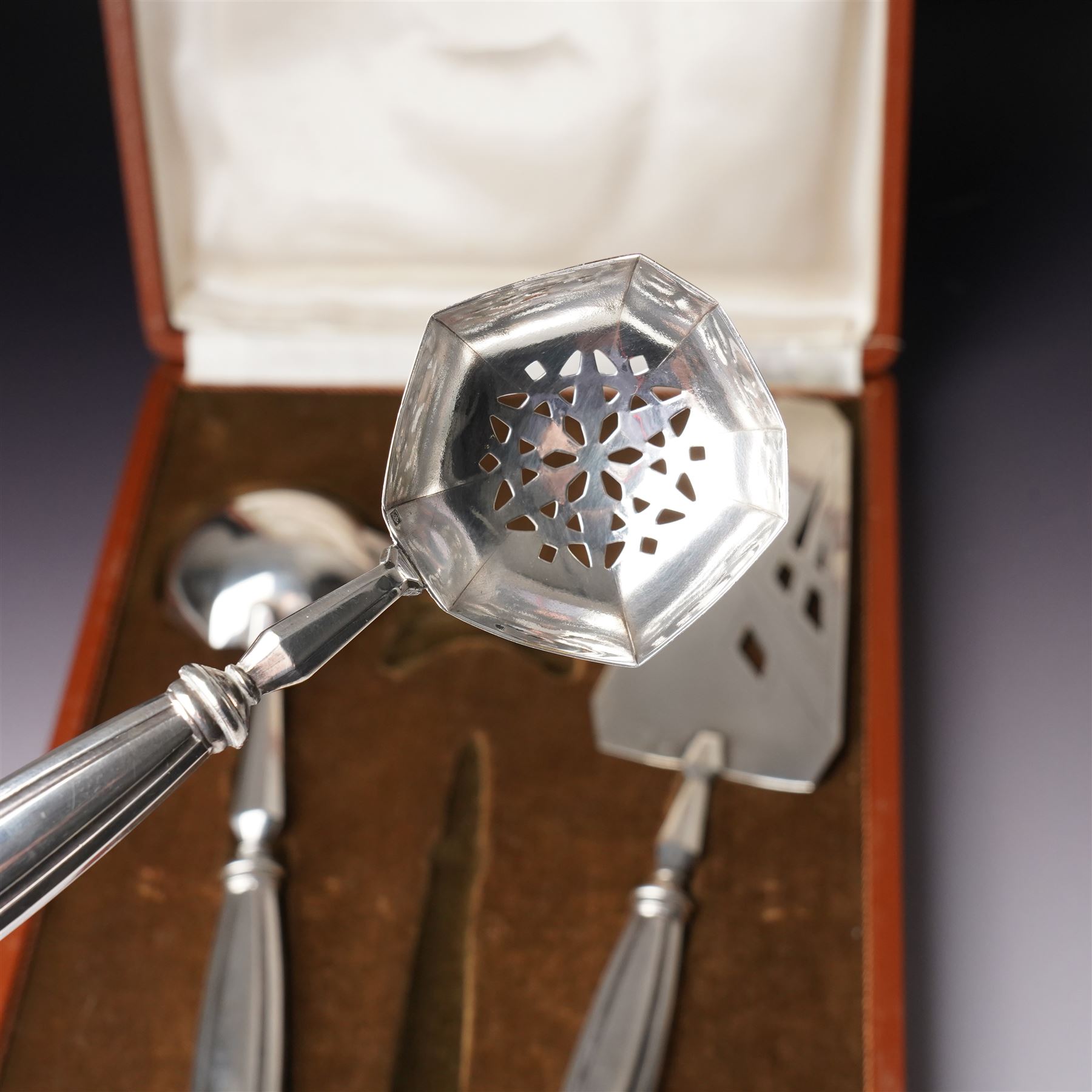 Scandinavian white metal three piece serving set comprising pastry slice, sauce ladle and sifting spoon with fluted handles, cased