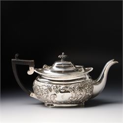 Late Victorian four piece silver tea set comprising teapot, coffee pot, sugar bowl and milk jug with embossed decoration, the cartouches engraved with an initial, the teapot and coffee pot Chester 1899 Maker George Nathan & Ridley Hayes, the sugar bowl and milk jug Birmingham 1899 Maker Thomas Hayes