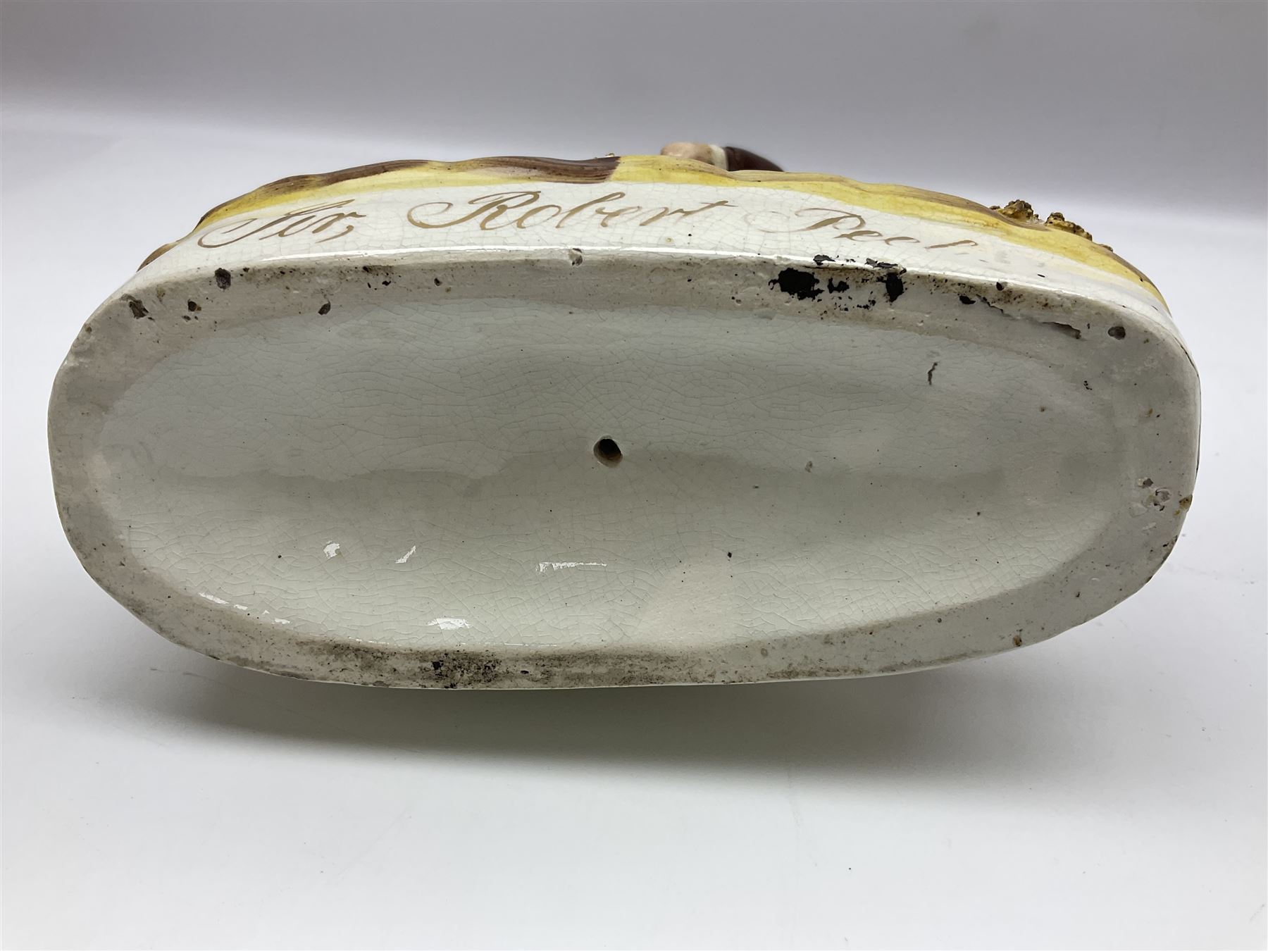 19th century Staffordshire figure of Robert Peel, titled 'Sir Robert Peel', modelled on horseback, atop an oval plinth base featuring a naturalistic and floral design, H30cm 