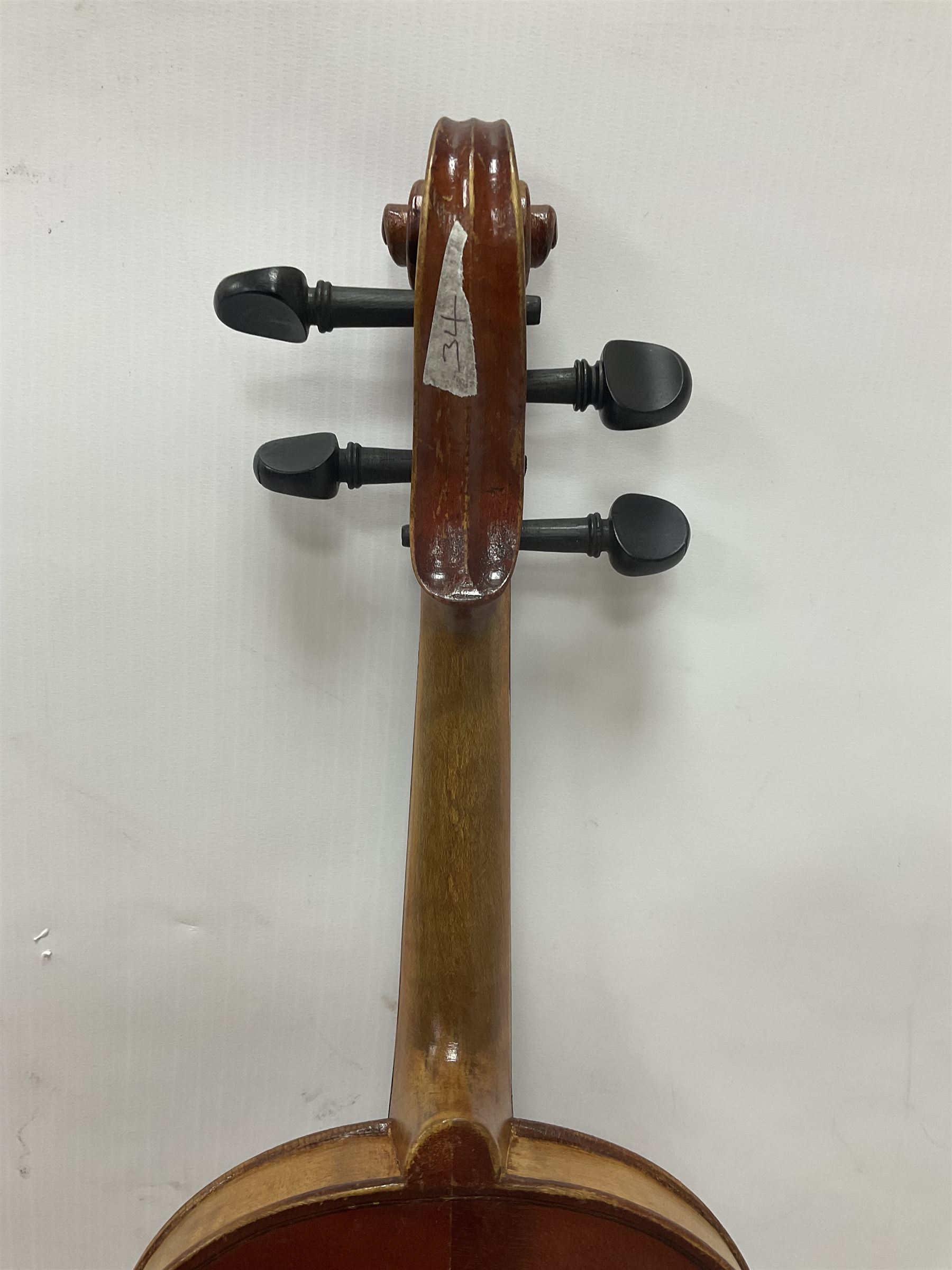 Copy of a full size Stradivarius violin, with an ebonised fingerboard, tailpiece and tuning pegs Length 60cm