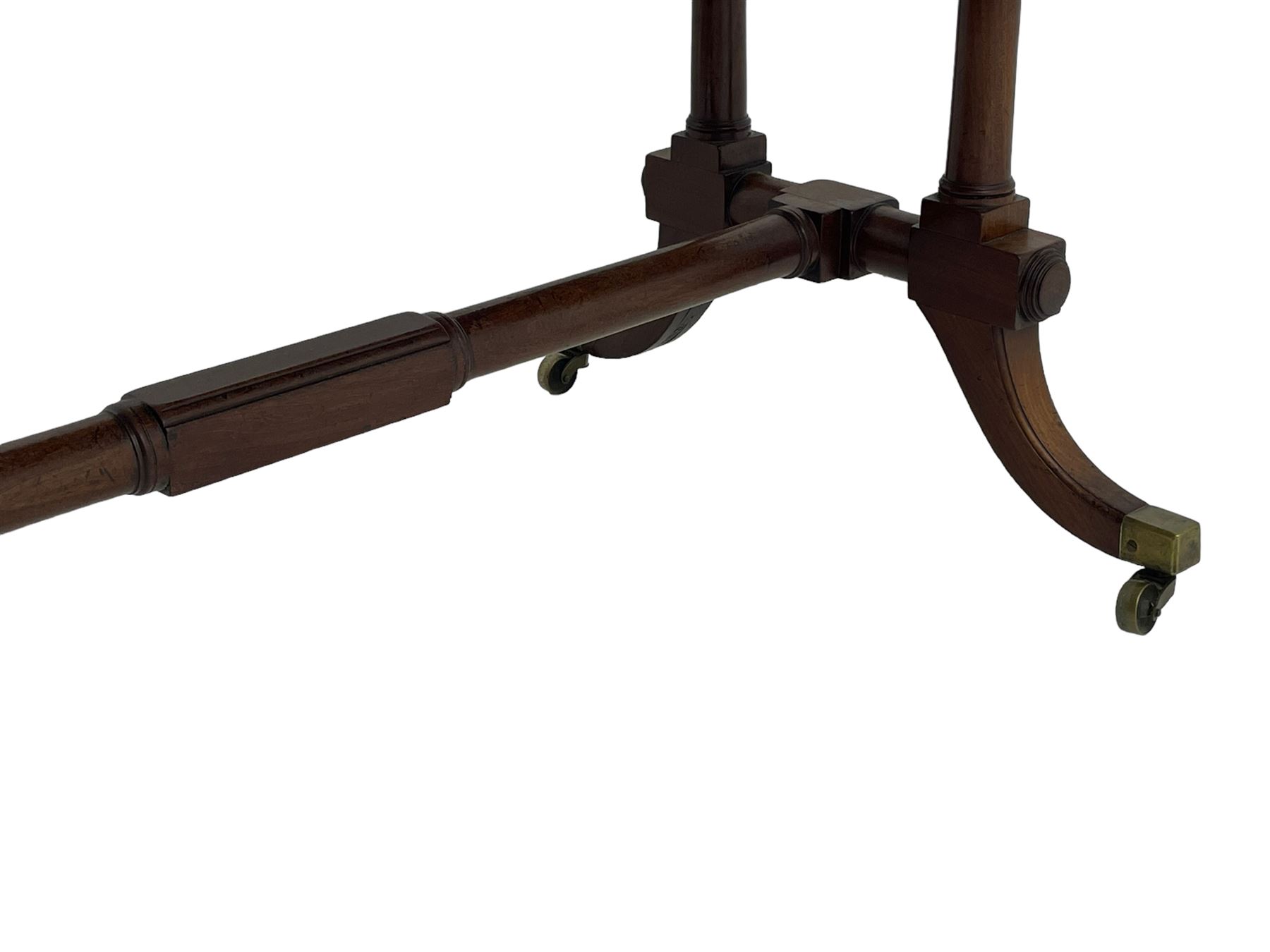 George III mahogany sofa table, rectangular drop-leaf top with reed moulded edge and rounded corners, fitted with two frieze drawers and two opposing false drawers, quadruple collar turned pillar supports on turned and block platforms, splayed and moulded supports with brass cups and castors 