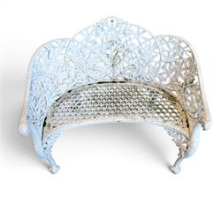 Victorian revival cast two seat garden bench, scrolling lattice back with flower heads, terminating to rams heads arms, curved pierced seat, finished in antique white paint