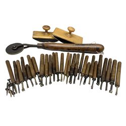 Thirty-one bookbinder's brass number and letter stamps, predominantly with beech handles, together with a bookbinder' decorative fillet roll, with brass triple line wheel stamped E. Menuel London, with wood handle, and two ink blotters