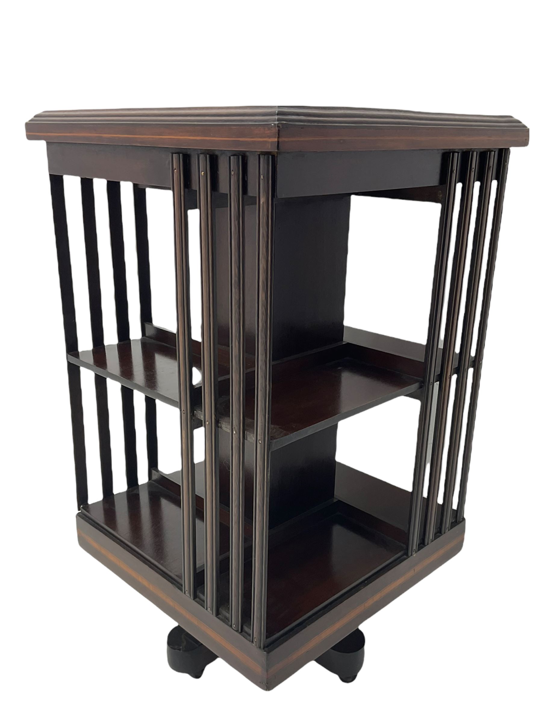 20th century mahogany revolving bookcase, inlaid centre motif, satinwood banded border