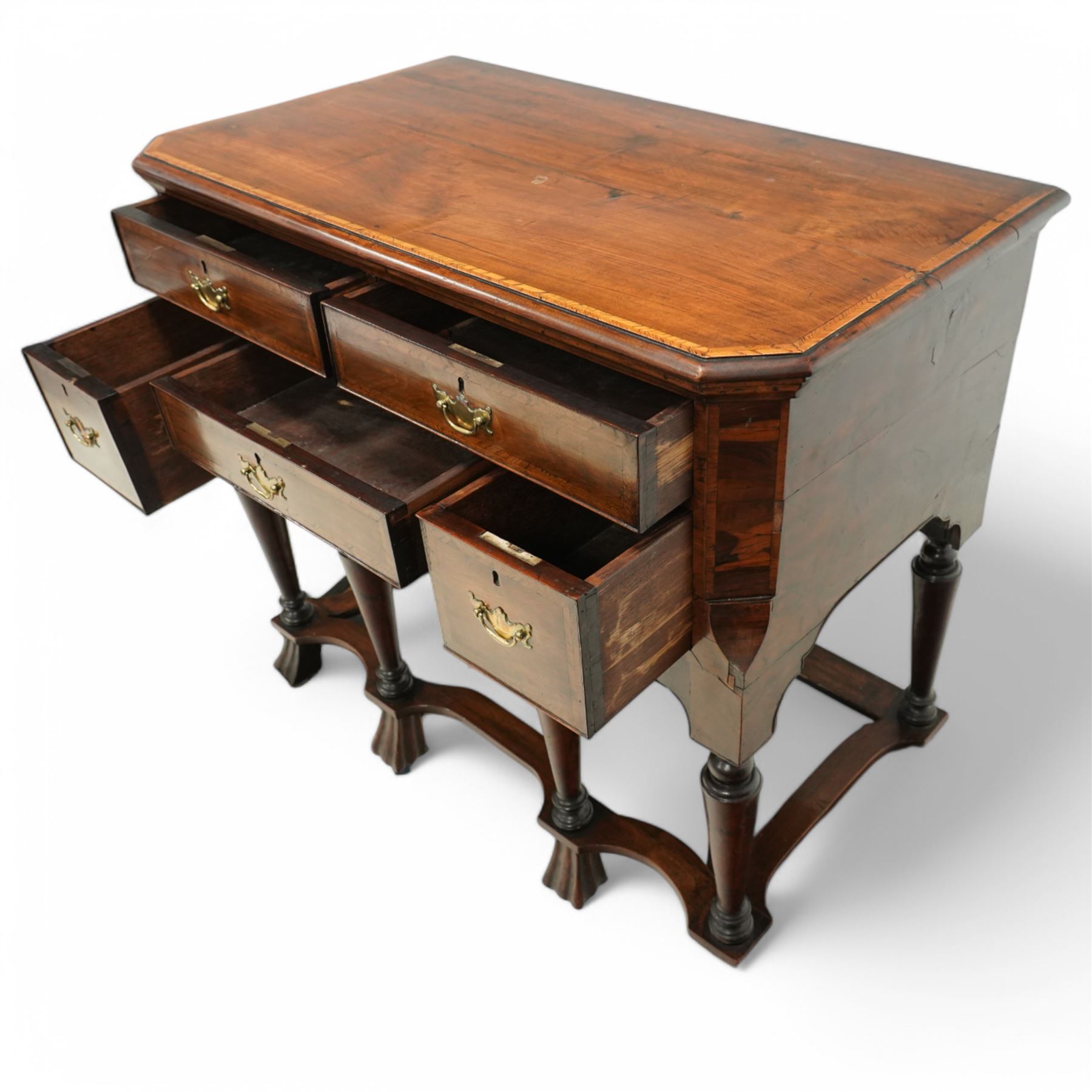 William and Mary design 18th century walnut and yew wood dresser or console table, rectangular canted top with feather banding and moulded edge, over two long and three short cock-beaded drawers, flanked by chamfered uprights above a shaped and cock-beaded apron, raised on six turned and tapering supports united by a shaped box stretcher, on lobed feet 