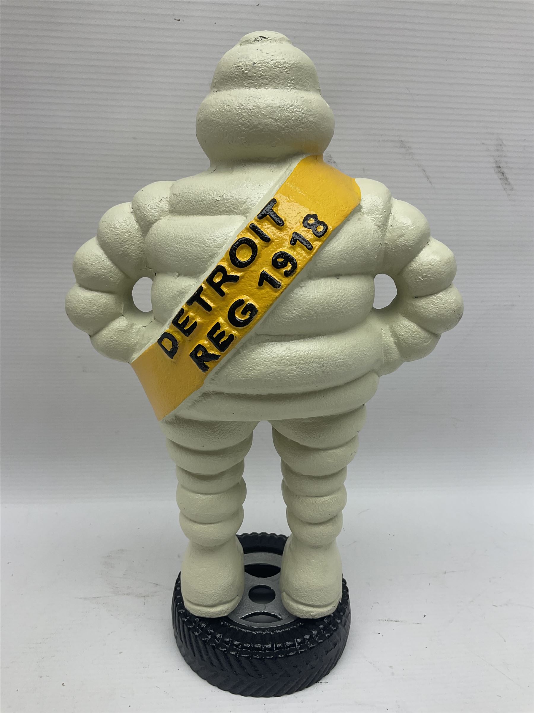 Cast iron figure of Michelin Man, stood on a tyre, H34cm 