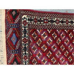 Persian red ground rug, blue and white geometric patterned field, repeating border