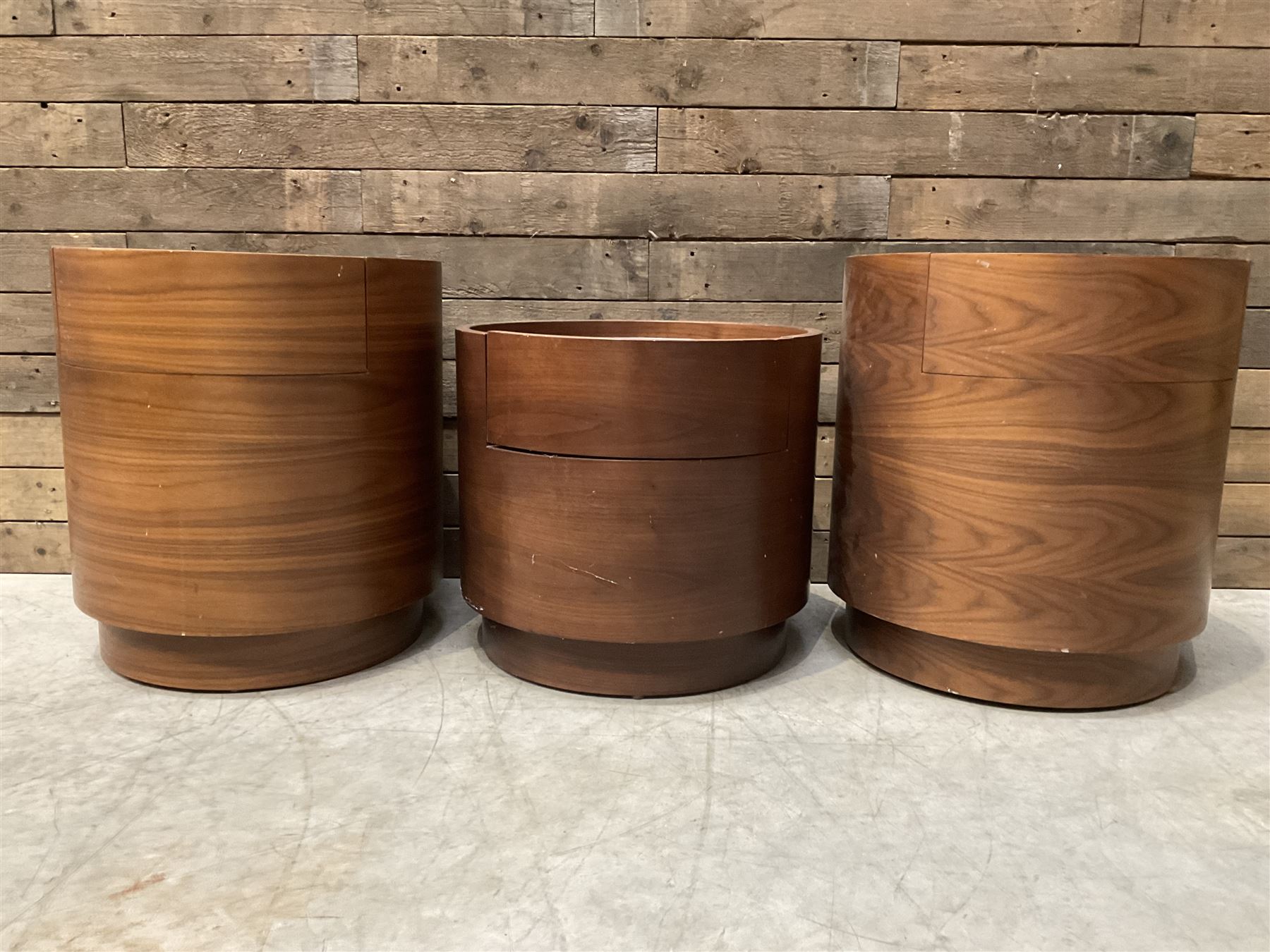 Three walnut circular barrel shaped lamp tables, fitted with single drawer (lower table D53cm, H49cm)