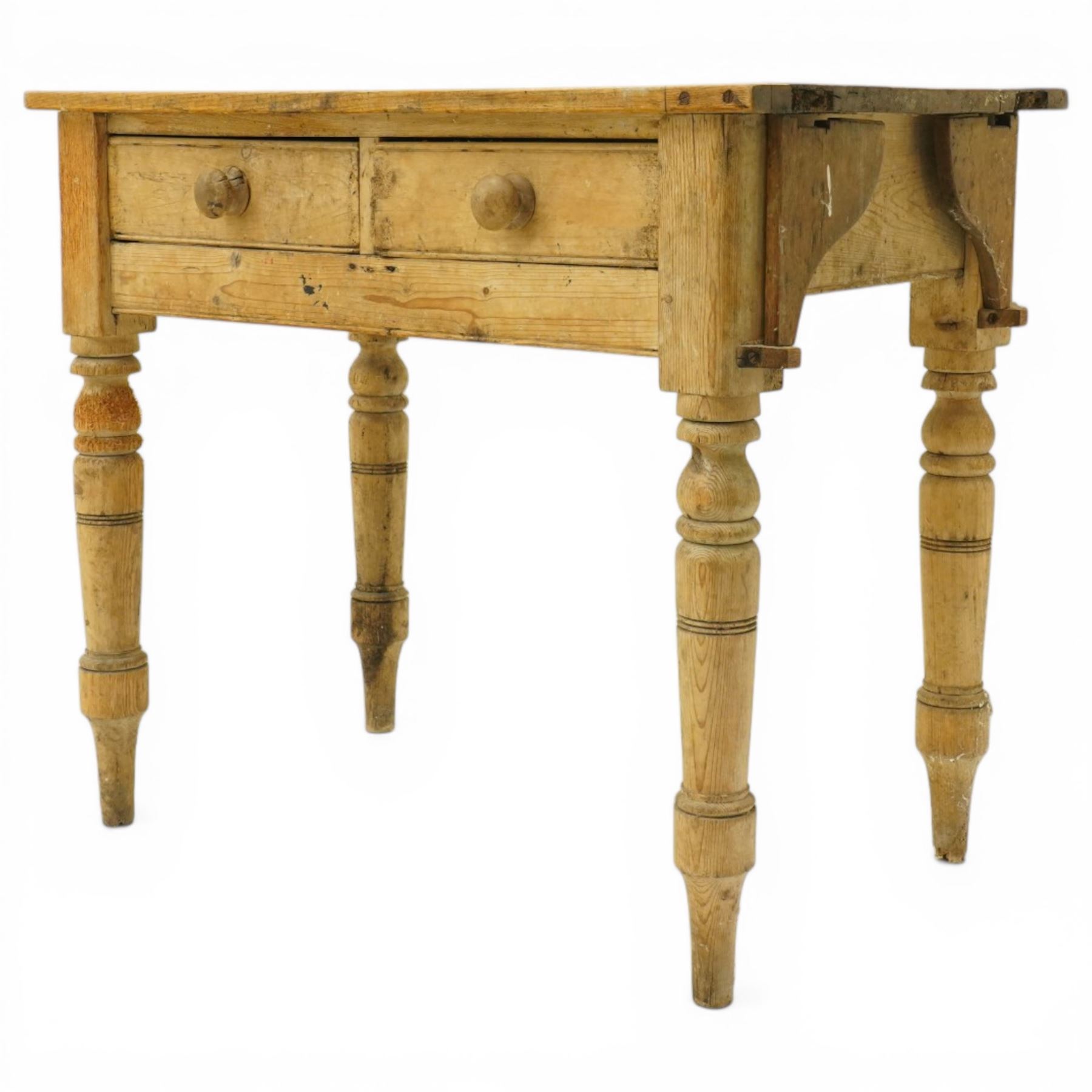 Victorian stripped pine table fitted with two drawers, supported on turned supports