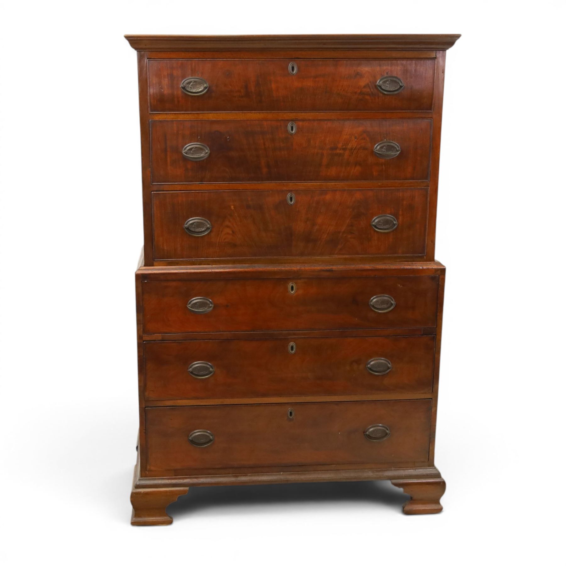 George III mahogany chest on chest, moulded cornice over two short over two long drawers with figured mahogany veneers, lower section fitted with three further long drawers, oval brass plate handles and escutcheons, on shaped bracket feet