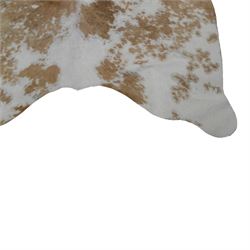 Skins/Hides: cow hide with brown and white dappled pattern together with another hide, possibly Mongolian goat