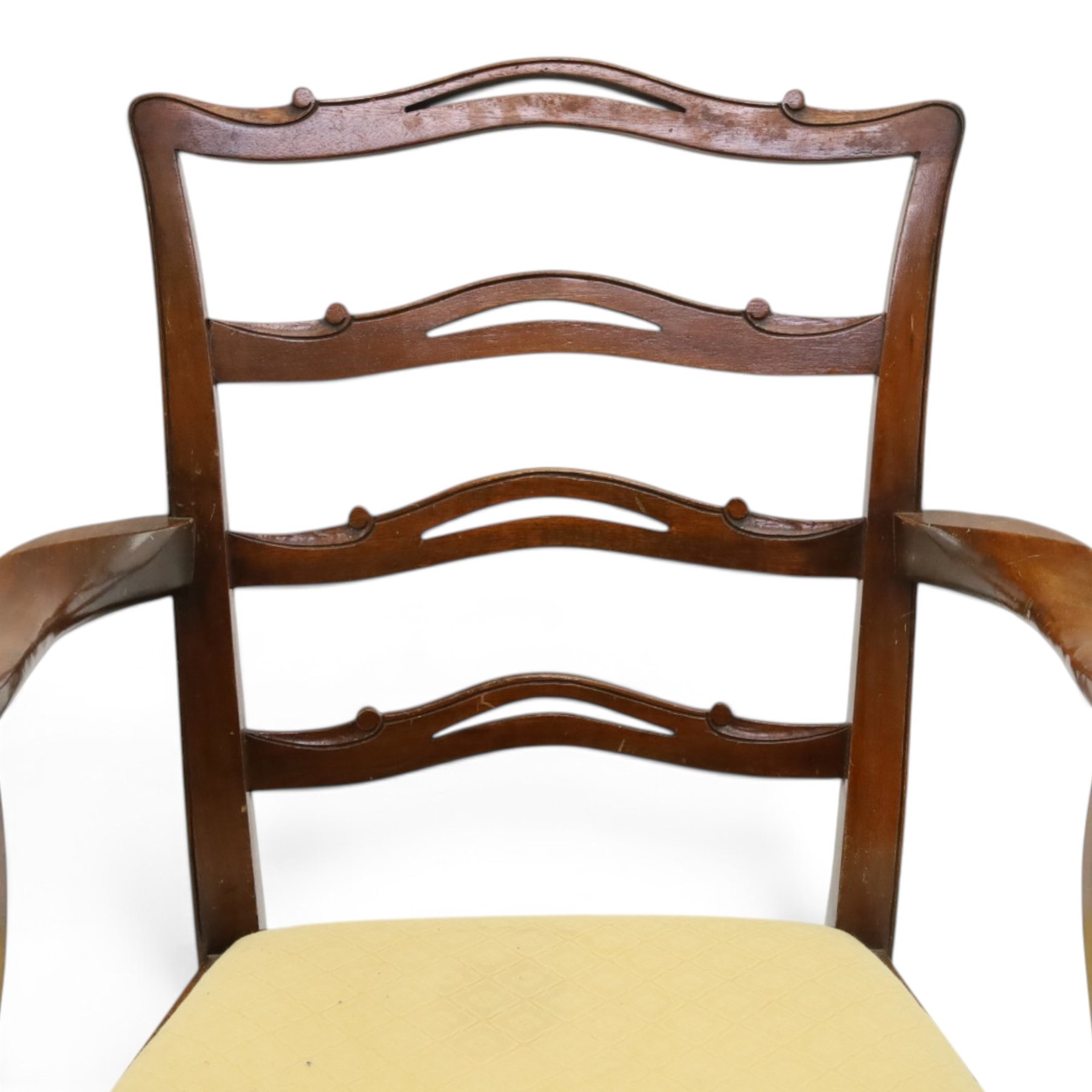 Pair of Georgian design Chippendale style mahogany elbow chairs, the pierced and waived ribbon ladder-back over scrolled arm terminals and yellow drop-in seats, on moulded and chamfered square supports