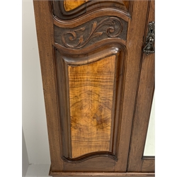 *Late Victorian walnut wardrobe, scrolled pediment with central carving, enclosed by single bevelled mirror glazed door, the front set with shaped figured panels and carved with scrolled foliage, single drawer to base, W134cm, D51cm, H220cm, 
