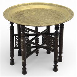 20th century Eastern brass charger topped table, the circular brass trap chased with an el...