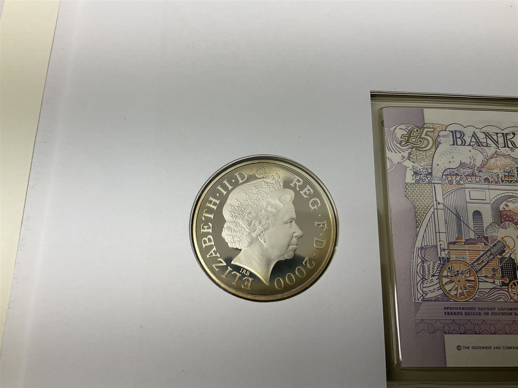 Four coin covers, comprising 2000 'The Queen Mother's 100th Birthday Silver Coin & Banknote Cover' limited edition 56/500, 2000 'Charles Darwin Commemorative Coin & Banknote Cover' limited edition 68/500, 2001 'Celebrating the 100th Birthday of Her Majesty The Queen Mother' containing  a 1999 silver one pound coin and 2001 'Royal Navy Submarines 100th Anniversary Cover' containing 2001 Turks & Caicos Islands 20 crowns silver coin