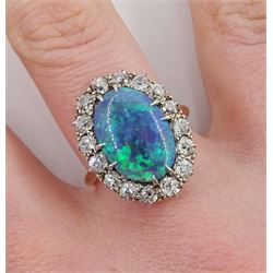 Mid 20th century 18ct gold oval black opal and old cut diamond cluster ring, opal approx 14mm x 9.8mm x depth 4.3mm, total diamond weight approx 0.90 carat, in velvet and silk lined box by Carmichael Ltd, Hull