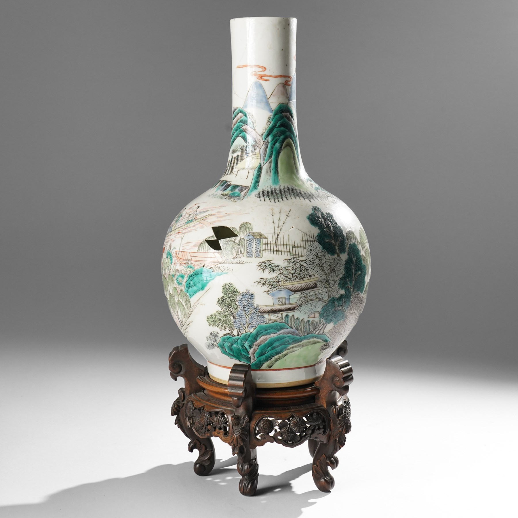 Chinese Kangxi period famille verte vase, the body finely painted with a continuous narrative scene of figures inside and out of a pavilion complex, beside a river, rocks and trees, character mark to base, raised upon a hardwood stand, overall H47cm