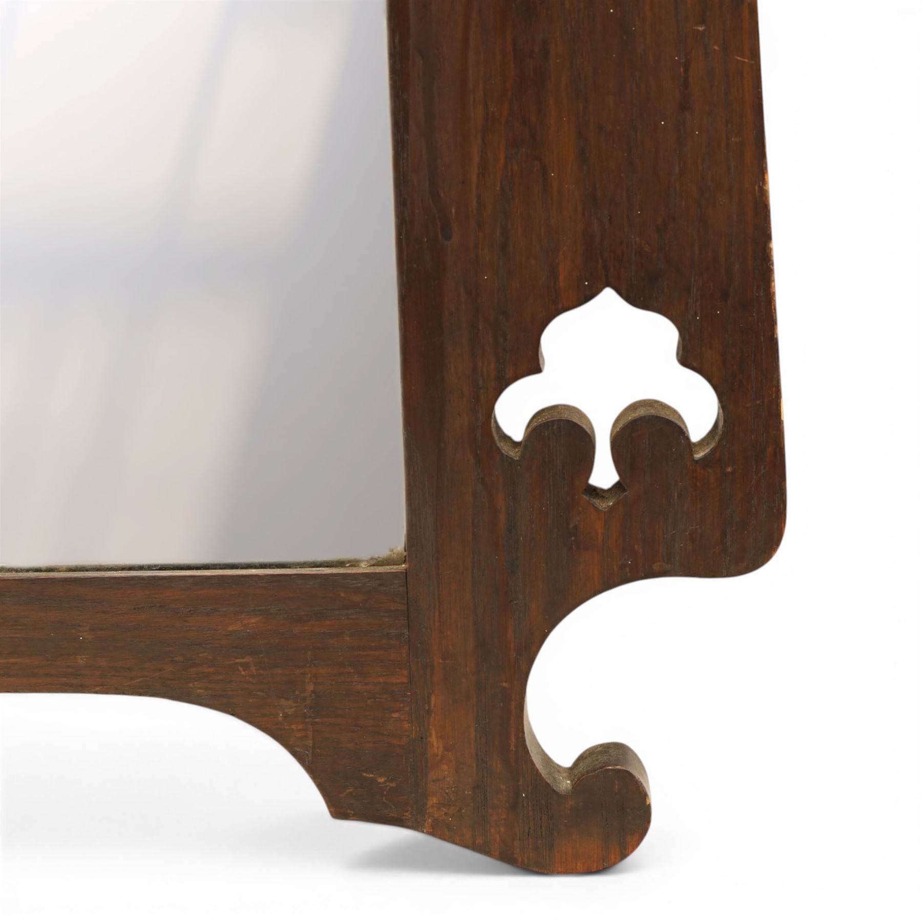 Arts and Crafts oak wall mirror, rectangular mirror plate within shaped frame, raised shelf with shaped back and pierced heart detail, bracket supports and shaped lower rail