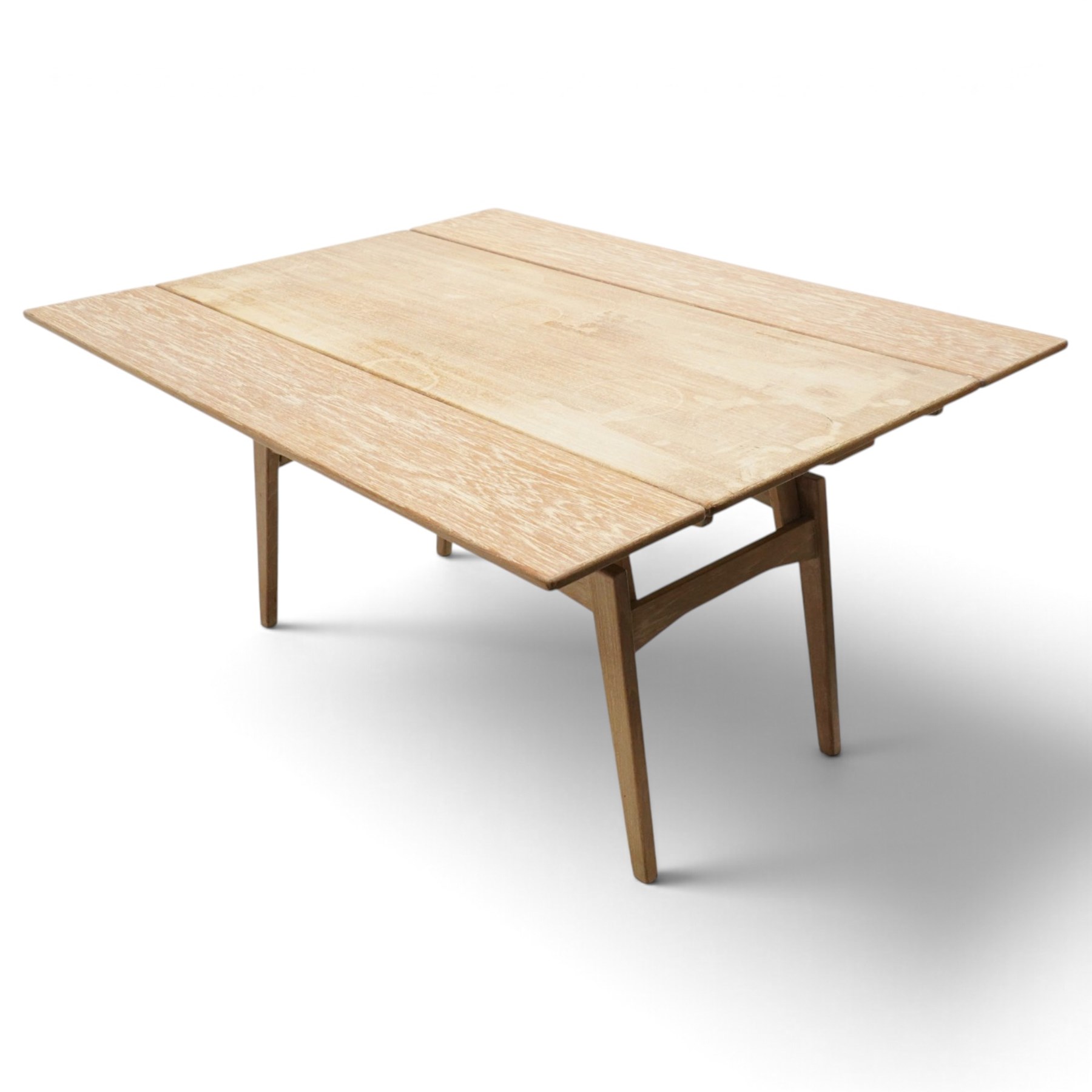 20th century Scandinavian limed oak metamorphic dining-to-coffee table, the rectangular extending top with draw-leaf sides, over an adjustable-height action base, on splayed supports united by stretchers