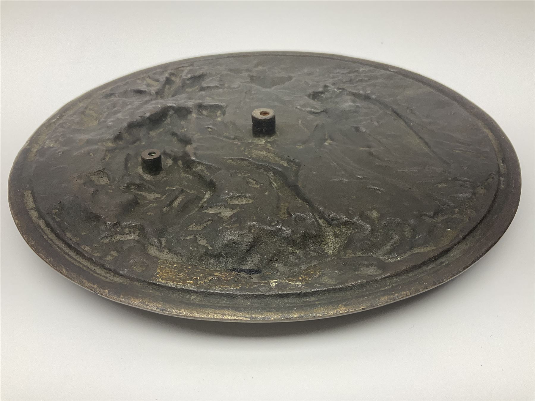 Late 19th century bronze plaque, of circular form, depicting the angel appearing to Adam and Eve in the garden of Eden in high relief, D25.5cm
