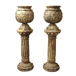  Pair 20th century carved marble planters on column pedestals, in the Neo-Classical style, the bulbous planters carved with trailing foliage and the pedestals with acanthus leaf capitals and circular stepped base, H166cm x D44cm   