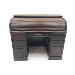  Early 20th century oak tambour roll top desk, two slides, eight drawers, plinth base, W123cm, H101cm, D71cm  