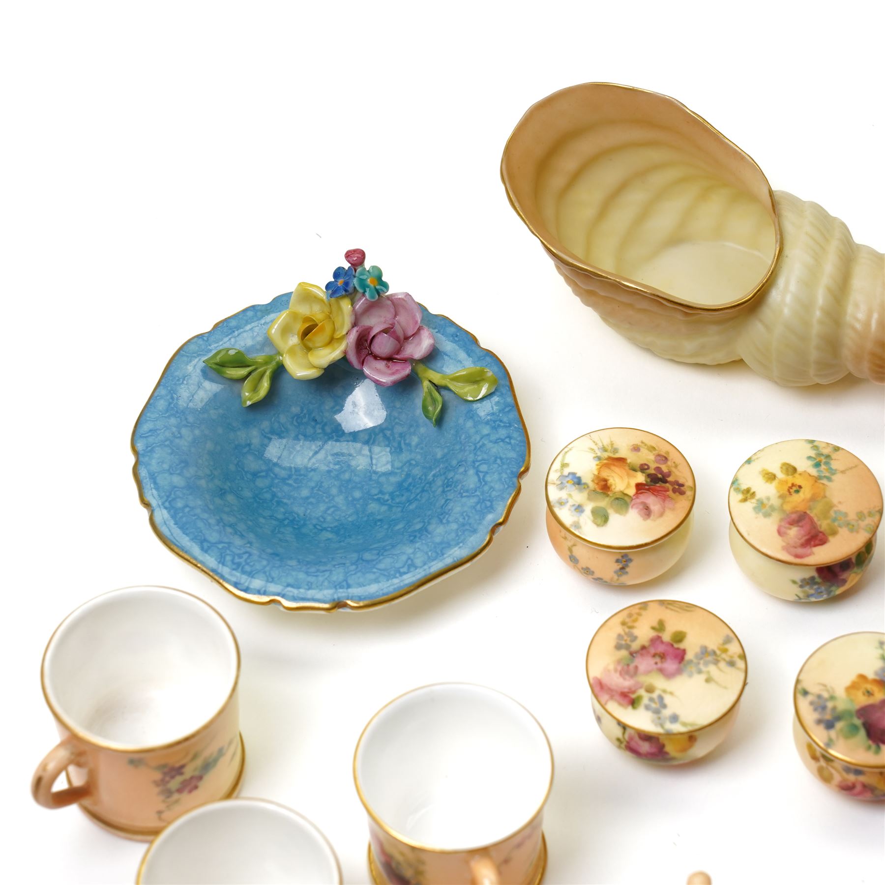 Large collection of miniature Royal Worcester hand-painted blush ivory wares, including shell shaped dish, and various covered trinket dishes, in glazed display case