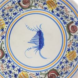 Pair of 20th century Spanish tin glazed polychrome plates, each painted with central foliate spray, within a stylised border, D32cm 