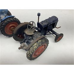Chad Valley - two unboxed and playworn large scale Fordson tractors - No.9235 Fordson Major Tractor, dark blue diecast body, orange wheels, crank handle clockwork mechanism and 'Firestone' rubber tyres; and No.M59 New Fordson Major Tractor, blue diecast body, tinplate hinged bonnet, orange wheels and clockwork motor contained in rear wheel hub (2)