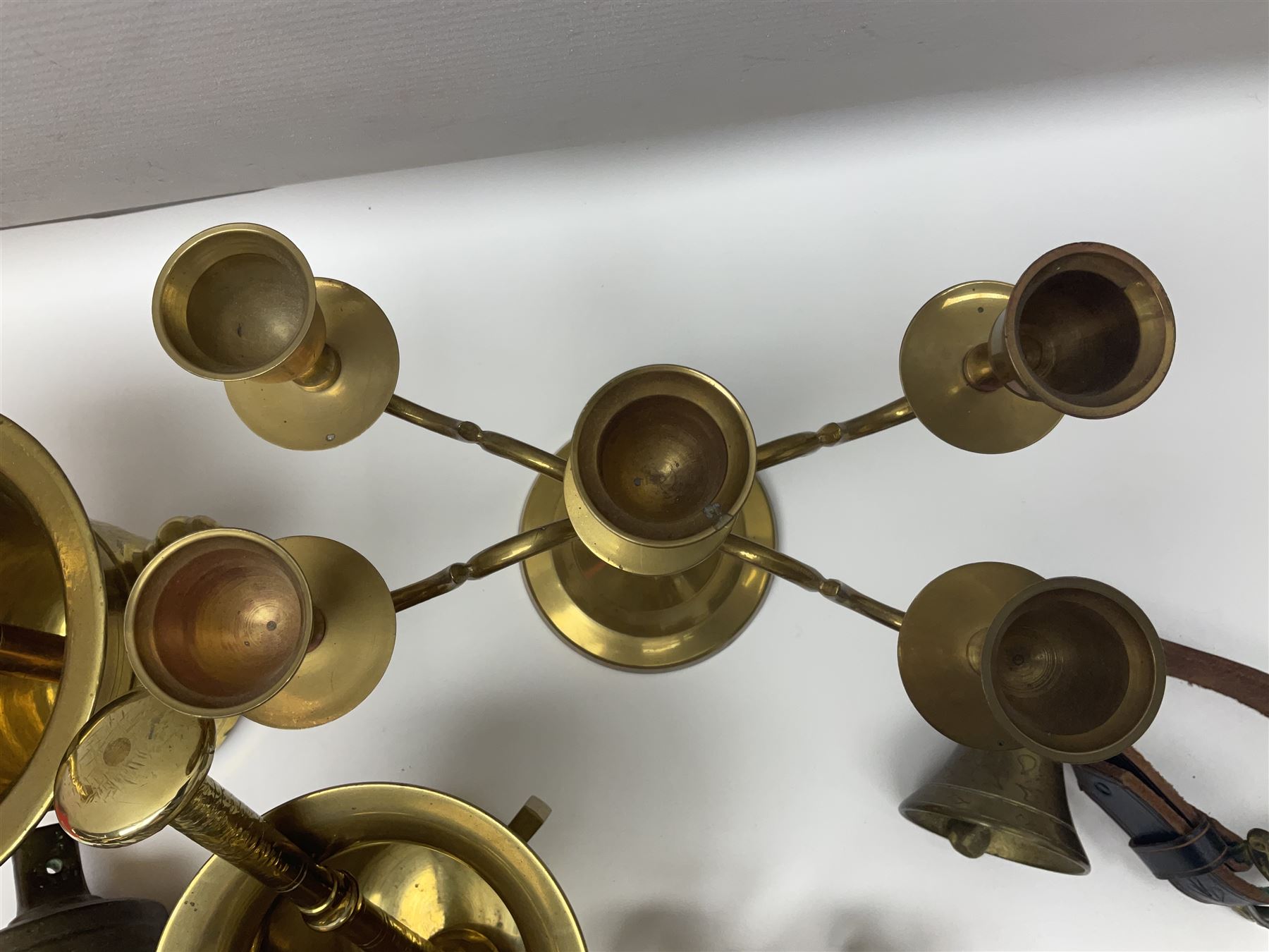 Four brass pestle and mortars, to include two miniature examples, together with other brassware including four branch candleabra, bells etc