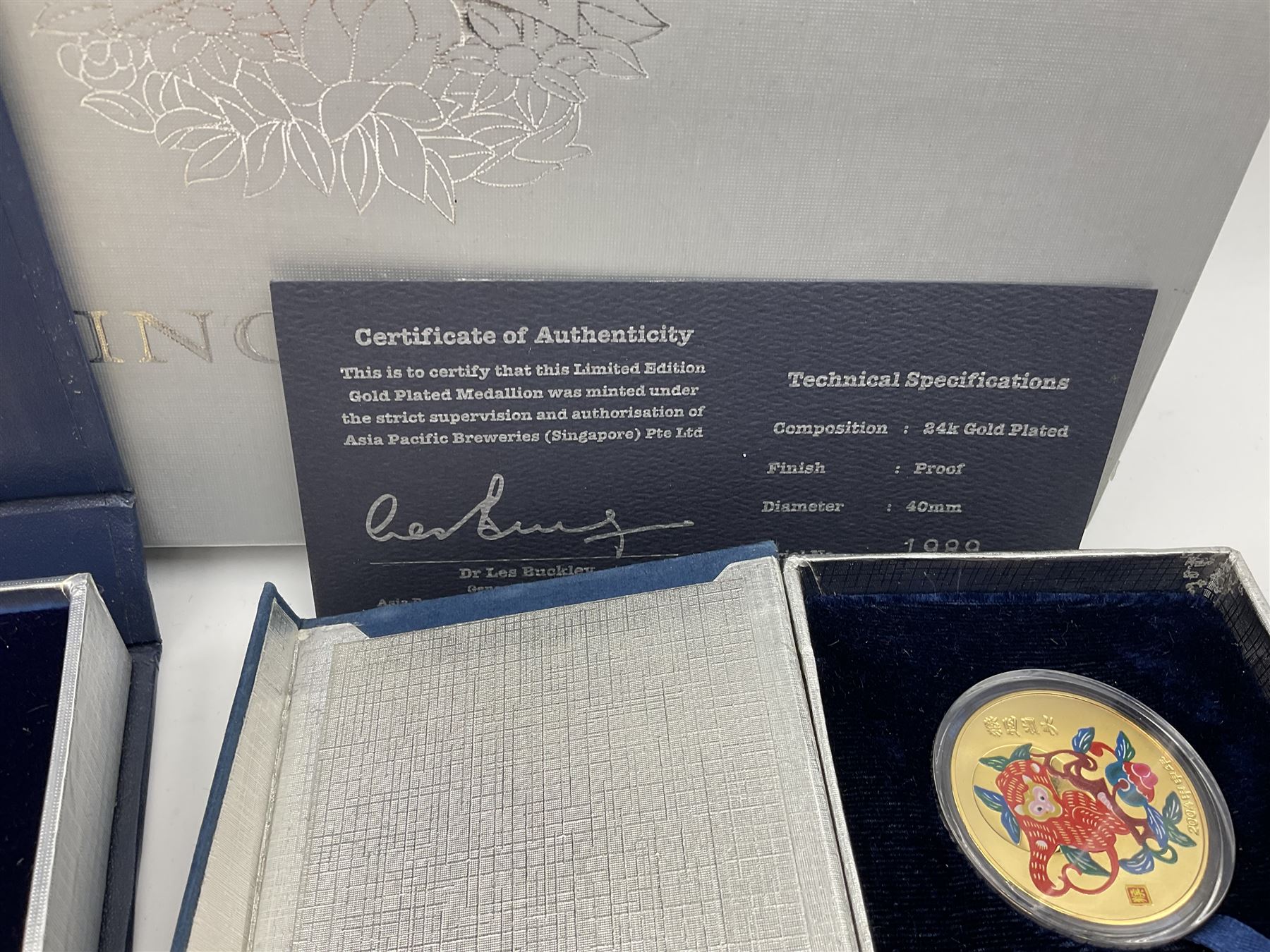 Singapore Venhonia commemorative medallion collection and a Tiger Beer commemorative three-medallion collection, both cased with certificates