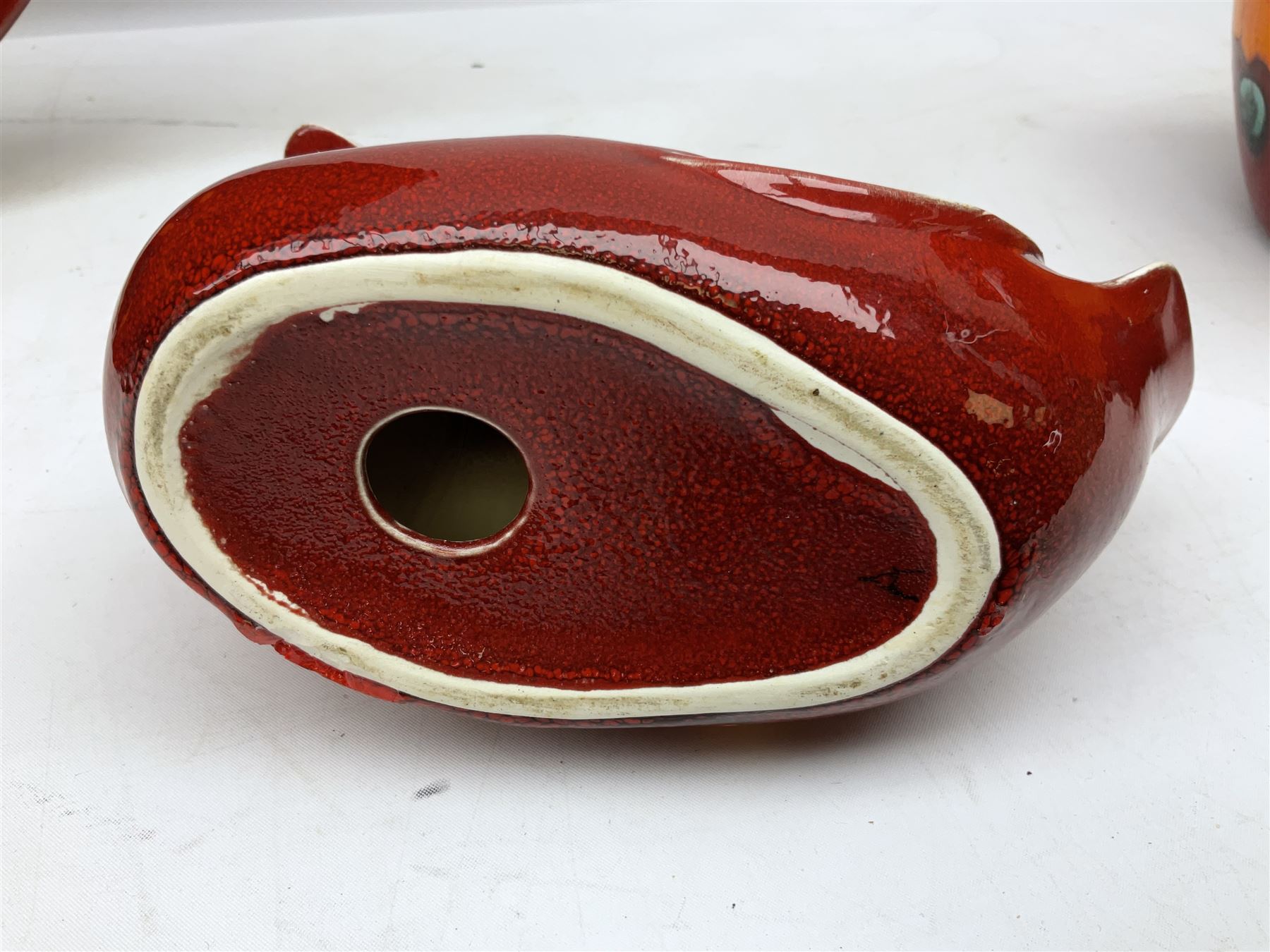 Collection of Poole Pottery, comprising charger and vase in Volcano pattern and a duck figure in a similar pattern 