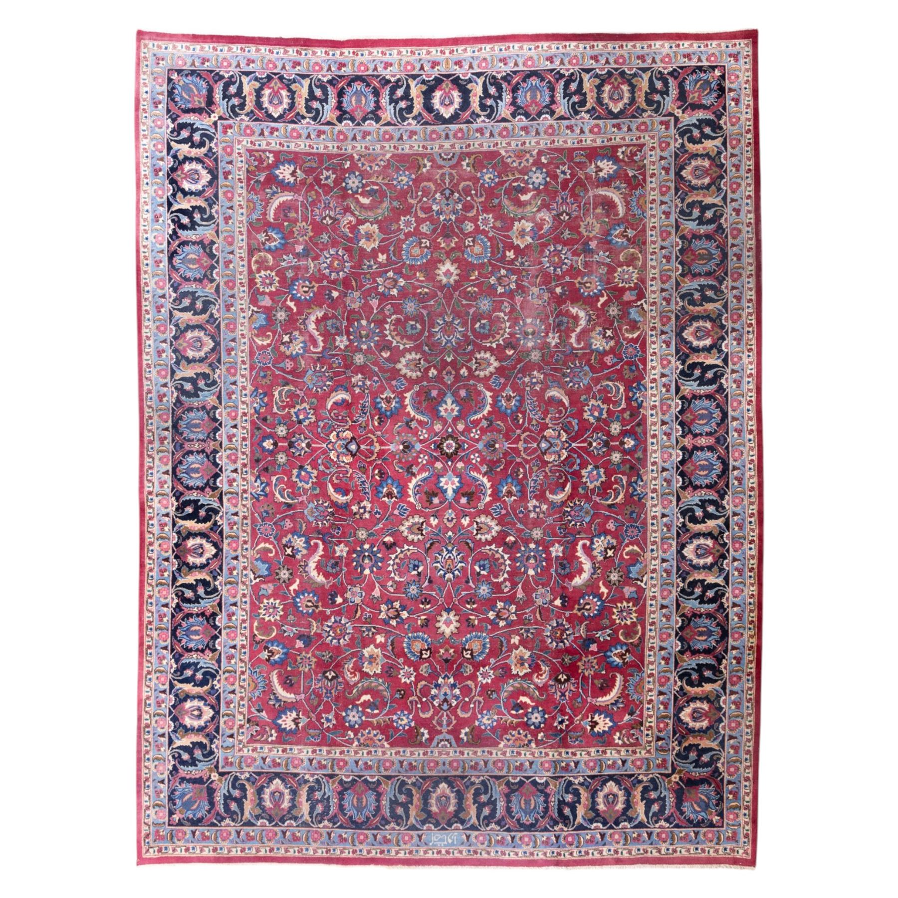 Persian Mashad design wool carpet, the red ground with dense scrolling floral and foliate decoration, within dark blue main border decorated with repeating palmettes and shaped leaves