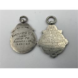 Seven early 20th century silver gold faced cartouche fobs, to include a circular example, with rose gold border and cartouche within an embossed yellow gold border, engraved verso, and a double sided example, all hallmarked with various dates and makers
