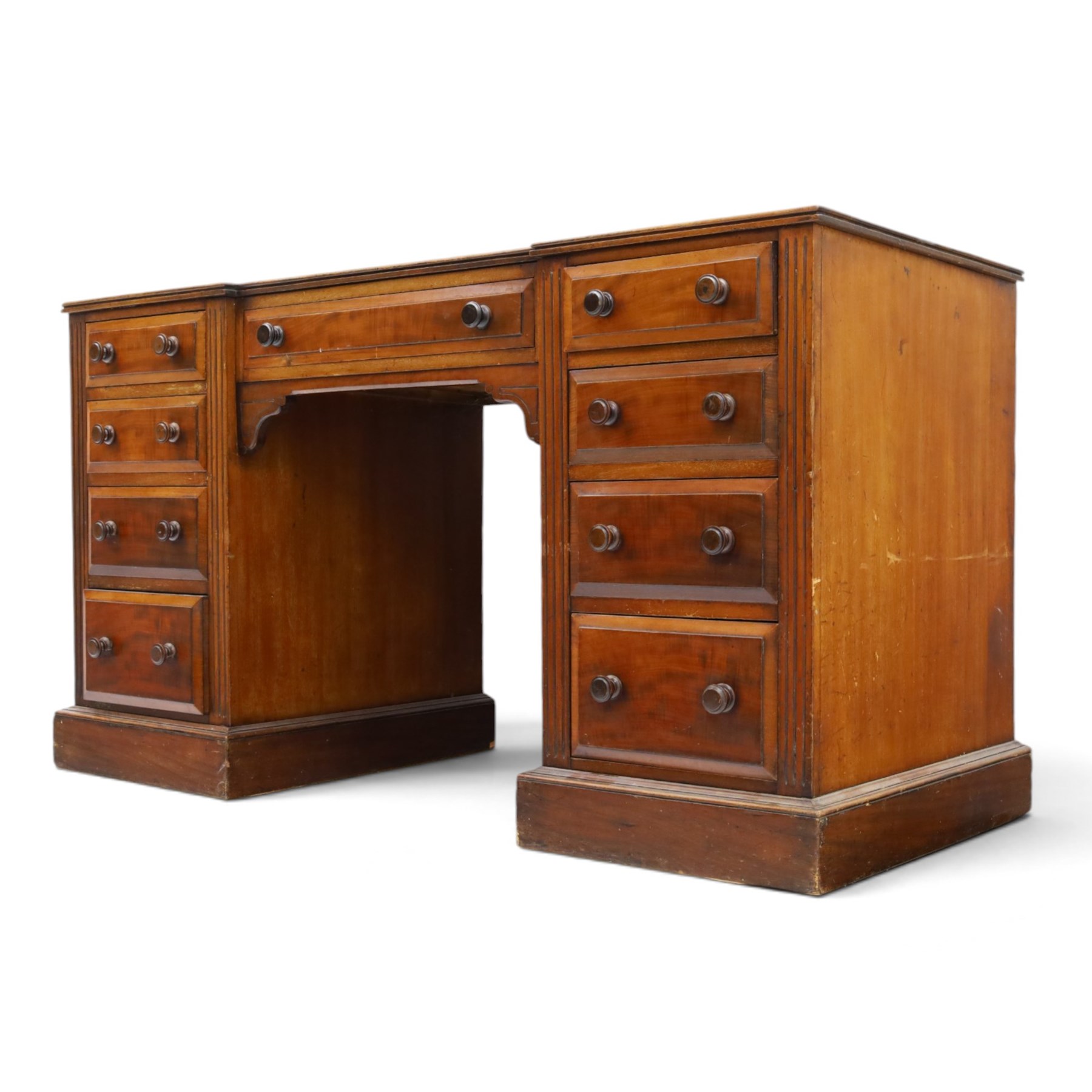 Victorian mahogany inverse breakfront twin pedestal desk, inset leather top over central drawer, flanked by pedestals with four graduating drawers, raised on a plinth base