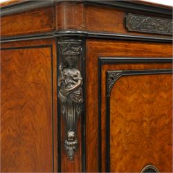 Lamb of Manchester (est. 1843) - Victorian Aesthetic Movement inlaid figured and burr walnut inverted-breakfront credenza, the shaped rectangular top with ebony banding and boxwood stringing, the frieze applied with bronze mounts decorated with foliate and scroll motifs, fitted with central glazed door flanked by panelled doors with central oval metal plaques depicting Classical Muses with lyre, the flanking canted uprights applied with caryatid maidens holding torches, acanthus terminal over skirted base
