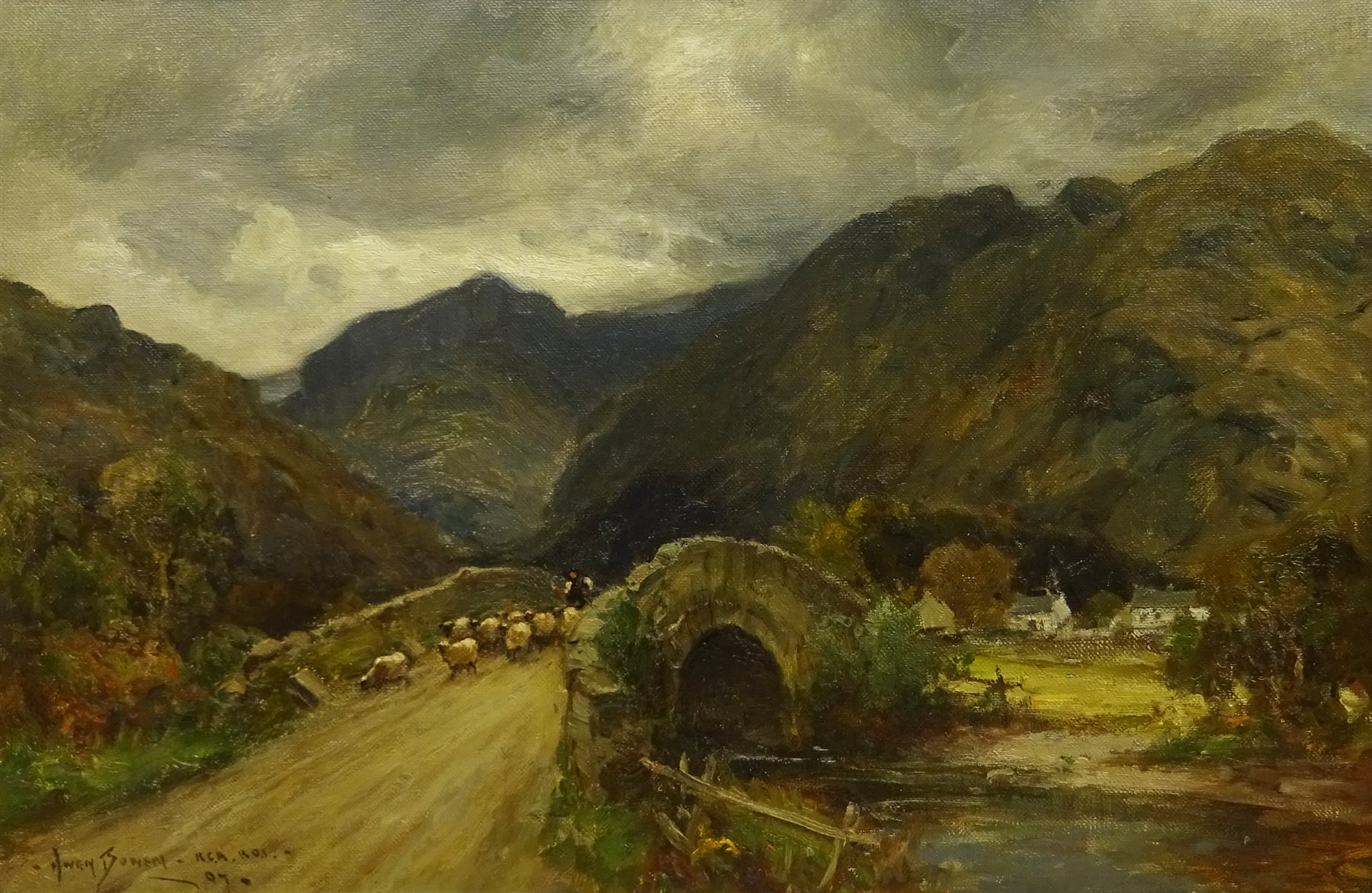 Owen Bowen (Staithes Group 1873-1967): Sheep crossing a Stone Bridge in the Lake District, oil on canvas signed and dated '07, 39cm x 60cm



