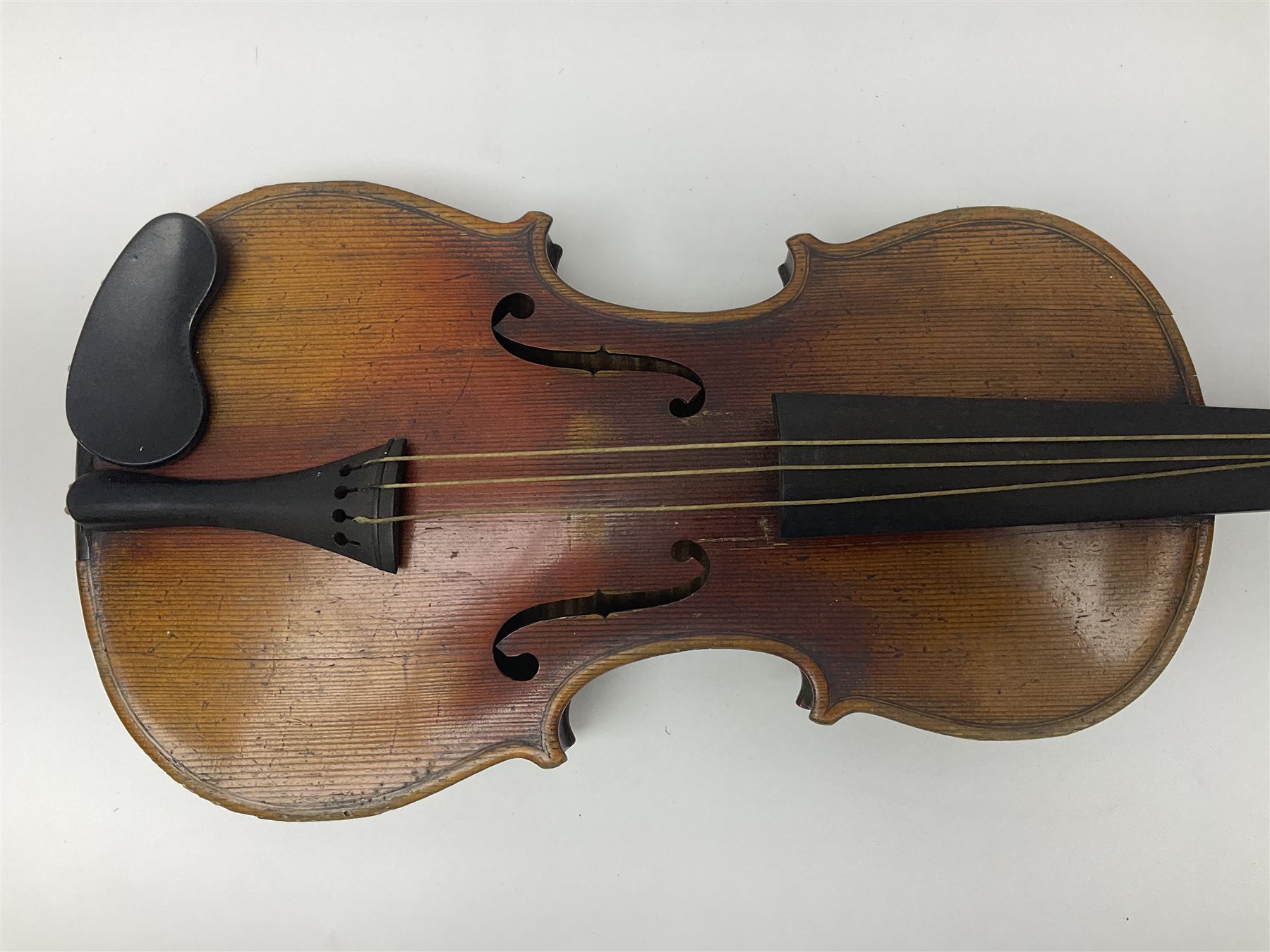 Late 19th century French three-quarter size 'Conservatory' violin with 34cm two-piece maple back and ribs and spruce top, the peg box inscribed 'Conservatory Violin Straduari', bears label 'Antonius Stradiuarius Cremonensis Faciebat Anno 1721' L55.5cm overall; in ebonised wooden 'coffin' case; and Saxony violin c1900 with 36cm two-piece maple back and ribs and spruce top; bears label 'Antonius Stradivarius Cremonensis Faciebat Anno 17**' L59cm overall; in carrying case (2)