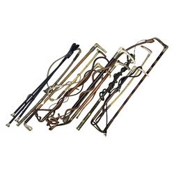 Collection of hunting crops and riding whips, including horn handle examples with silver cuffs