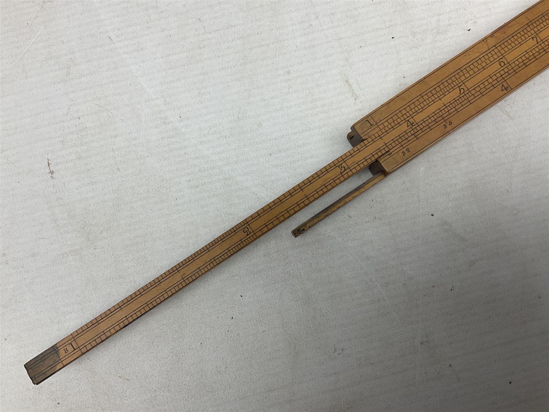Late 18th/early 19th century boxwood ruler with four slides, for use by Customs &. Excise in the brewery trade; scales on all four sides each having a central slide with divisions on either side;  possibly made by 'E. Roberts, Dove Court, Old Jewry, London' (Edward Roberts (I) 1749-1776 & Edward Roberts (II) 1788-1795) L30.5cm