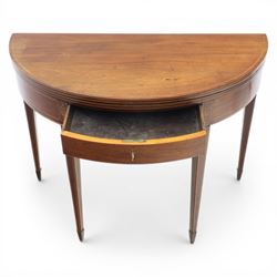 George III Scottish inlaid mahogany demi lune tea table, the curved fold over top opening to reveal a circular top with inlay to edge, above a frieze drawer with key, raised upon tapering inlaid legs with spade feet