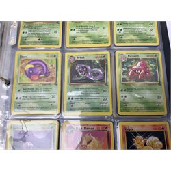 Collection of Pokemon trading cards, mostly 1999 Wizards Pokemon cards to include holo Charizard 4/102, first edition holo Machamp 8/102, further holographic cards; Dark Flareon 35/82 and Dark Vaporeon 45/82, cards from themed sets and 4th edition prints; 1998 Electronic Pokédex with cardboard boxes for themed decks Blackout, Overgrowth and Power Reserve Jungle, along with a large quantity of energy and trainer cards 