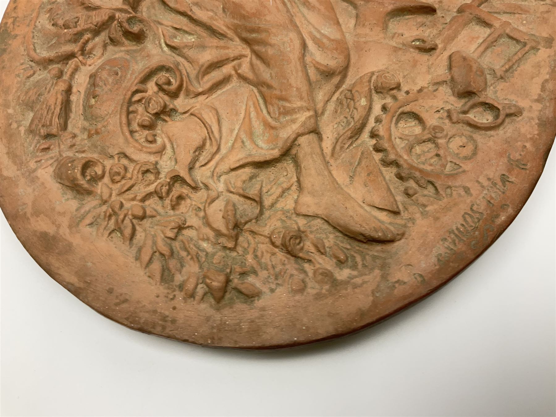 Pair of 19th century classical terracotta relief wall plaques depicting the goddess Hygeia and another goddess, seated holding an ewer, each of oval form, indistinctly signed, each stamped Ferreira verso, H42cm, W30cm