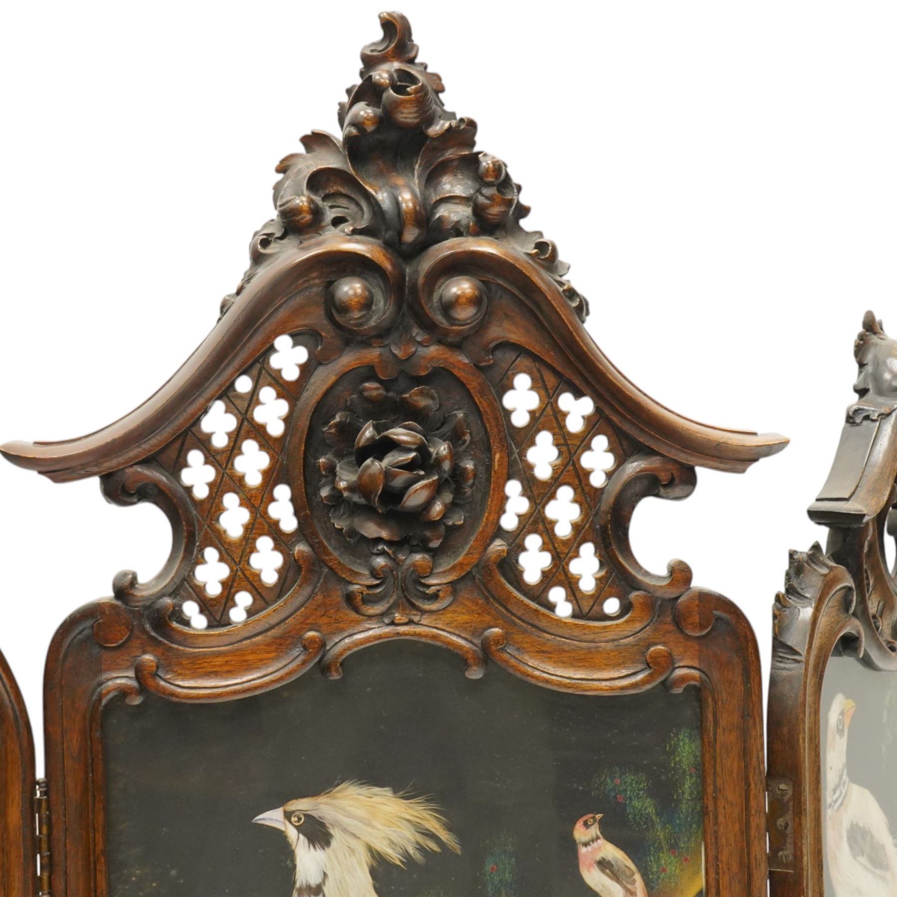 Rococo Revival carved hardwood framed triple panel fire screen, pierced and carved foliate and cartouche pediments with C-scrolls and scallop decoration, over three glazed panels depicting exotic birds of Mexican feather art, on cabriole supports with scroll feet