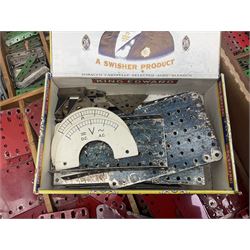 Meccano - large quantity of loose parts including various plates and strips, flanged plates, pulleys, axle rods and crank handles, wheels and tyres, gear wheels, brackets, nuts & bolts, various manuals; predominantly red and green; some in compartmentalised wooden trays