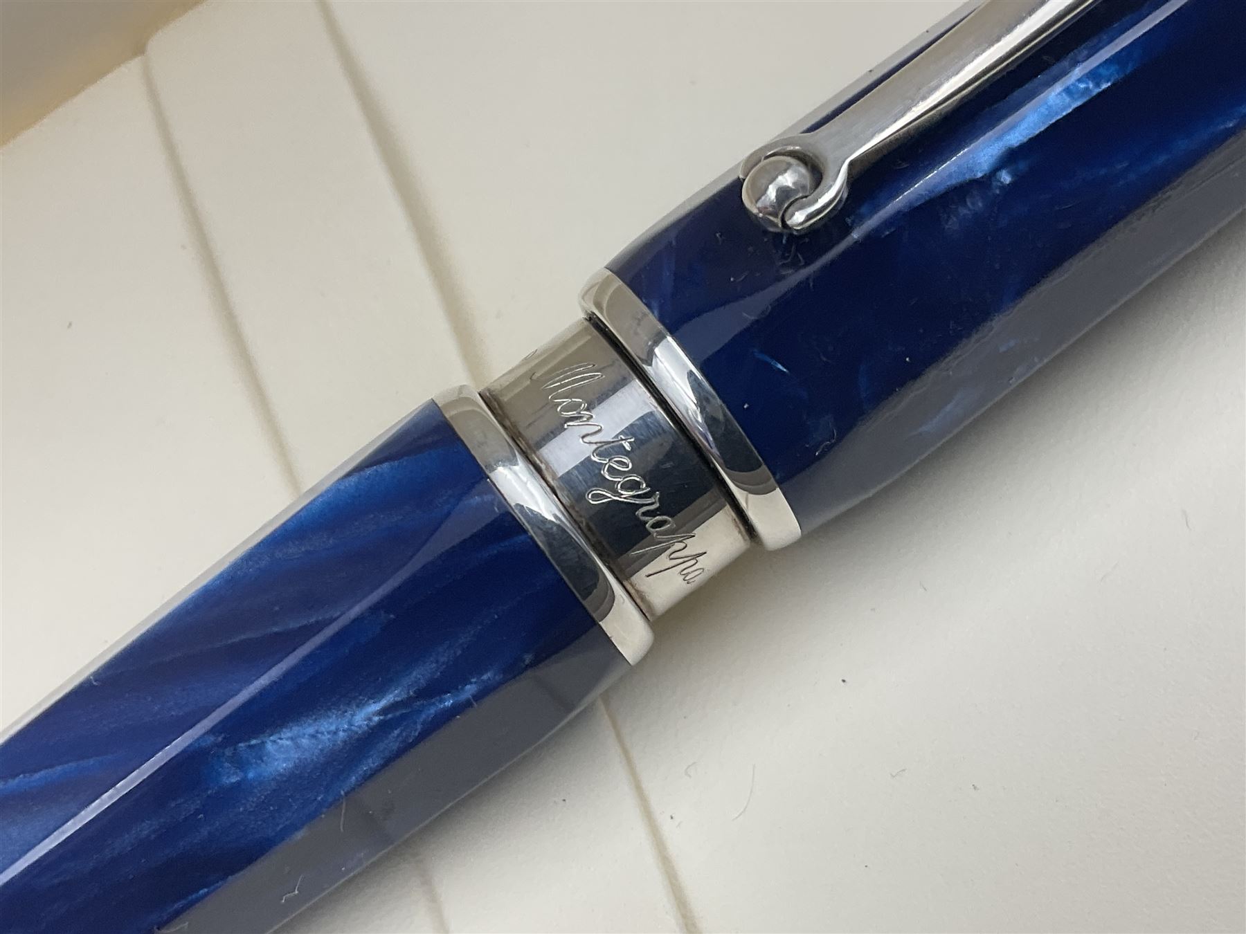 Montegrappa Emblema ball pen, the blue pearl marbled barrel of octagonal form with silver mounts and terminal with 1912 emblem, stamped 925 and clip with roller, in box, L13.5cm