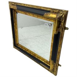 Victorian design ebonised and gilt wall mirror, the moulded rectangular frame decorated with foliate cartouches, bevelled mirror plate 