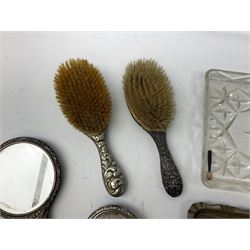Glass dressing table tray, scent bottles and lidded bowl, metal mounted foliate design hair brushes and handheld mirrors etc