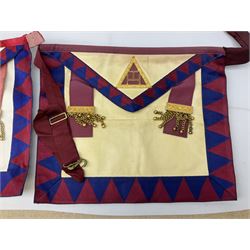 Two Masonic kid leather aprons, one with sash and cuffs, the other with sash, each marked 'Yorkshire North and East Ridings'; and three other unmarked Masonic aprons with sashes